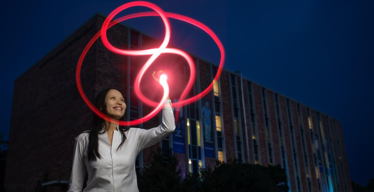 Dr. Christine Ruey Shan Lee traces a figure-eight knot with light outside the Mathematical Sciences and Physics Building at the University of South Alabama. Her research in quantum topology earned a grant from the National Science Foundation.  